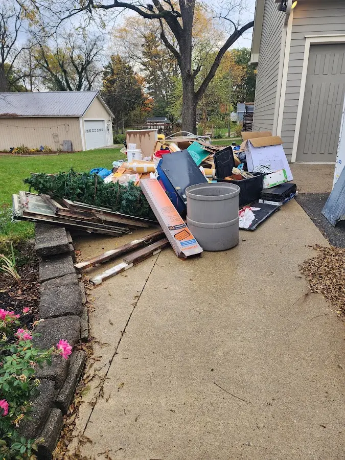 Dumpster being loaded with debris for 10 Yard Dumpster Rental in Killeen